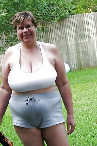 Young, overweight girl on bed, sensually touching herself